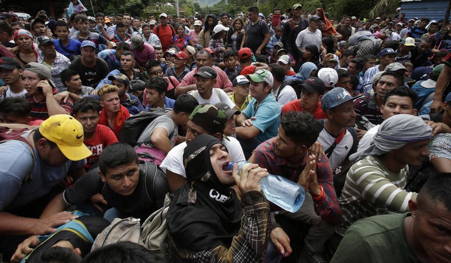 Hundreds of Hondurans are blocked at the border crossing in Agua Caliente, Guatemala, Monday, Oct. 15, 2018. A caravan of Honduran migrant moved towards the country&#x27;s border with Guatemala in a desperate attempt to flee poverty and seek new lives in the United States. (AP Photo/Moises Castillo)