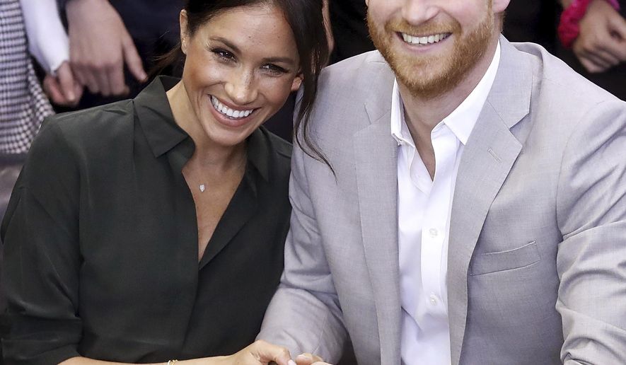 FILE - In this file photo dated Wednesday Oct. 3, 2018, Meghan, Duchess of Sussex and Britain&#39;s Prince Harry, make an official visit to the Joff Youth Centre in Peacehaven, Britain.  Kensington Palace announced Monday Oct. 15, 2018, that Prince Harry and his wife the Duchess of Sussex are expecting a child in spring 2019.  (Chris Jackson/pool via AP)