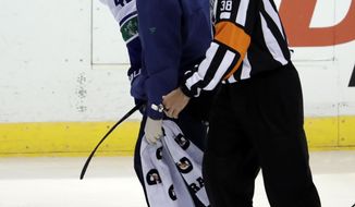 FILE - In this Saturday, Oct. 13, 2018, file photo, Vancouver Canucks center Elias Pettersson (40) is led off the ice after an injury during the third period of an NHL hockey game against the Florida Panthers, in Sunrise, Fla. The Vancouver Canucks say rookie forward Elias Pettersson is in concussion protocol. The loss of Pettersson for any significant length of time will be a blow to the rebuilding Canucks. (AP Photo/Lynne Sladky, File)