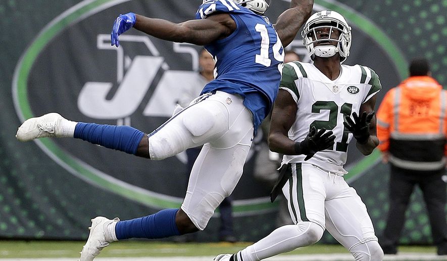 Indianapolis Colts wide receiver Zach Pascal (14) is unable to catch a pass from quarterback Andrew Luck, not pictured, as New York Jets cornerback Morris Claiborne (21) defends during the second half of an NFL football game, Sunday, Oct. 14, 2018, in East Rutherford, N.J. (AP Photo/Seth Wenig)