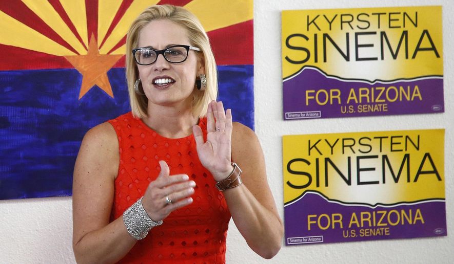 Rep. Kyrsten Sinema, D-Ariz., talks to campaign volunteers at a Democratic campaign office on primary election day in Phoenix.  (AP Photo/Ross D. Franklin, file)