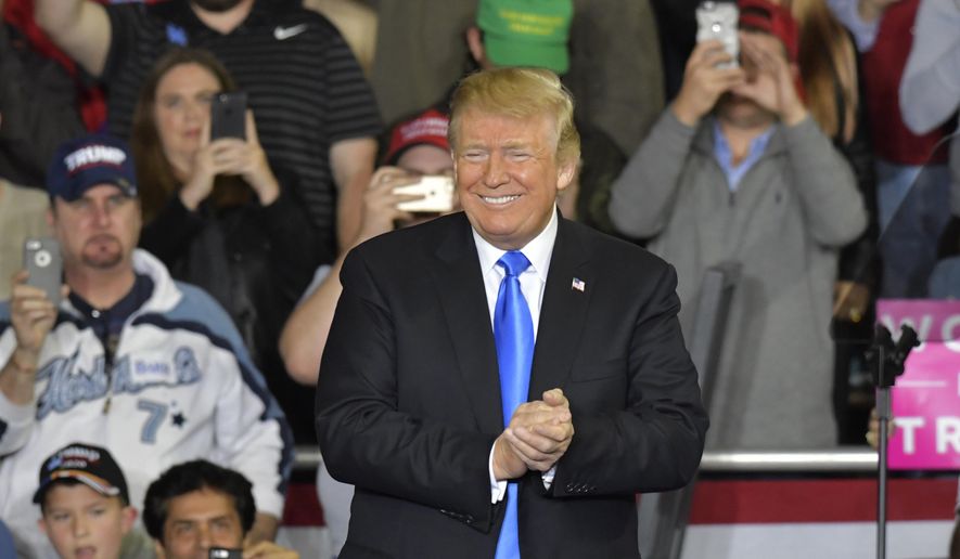 President Donald Trump smiles as he arrives at a rally at Eastern Kentucky University, Saturday, Oct. 13, 2018, in Richmond, Ky. (AP Photo/Timothy D. Easley)