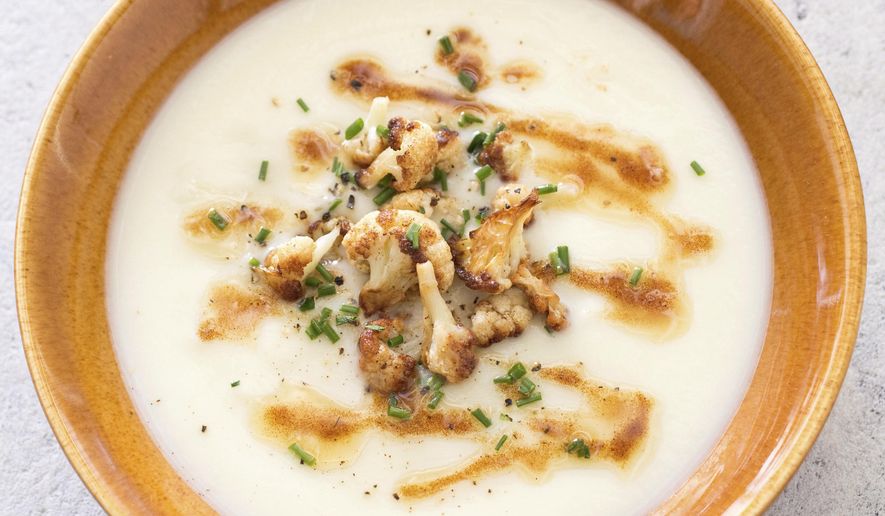 This undated photo provided by America&#39;s Test Kitchen in October 2018 shows creamy cauliflower soup in Brookline, Mass. This recipe appears in the cookbook “Cooking at Home with Bridget and Julia.” (Carl Tremblay/America&#39;s Test Kitchen via AP)
