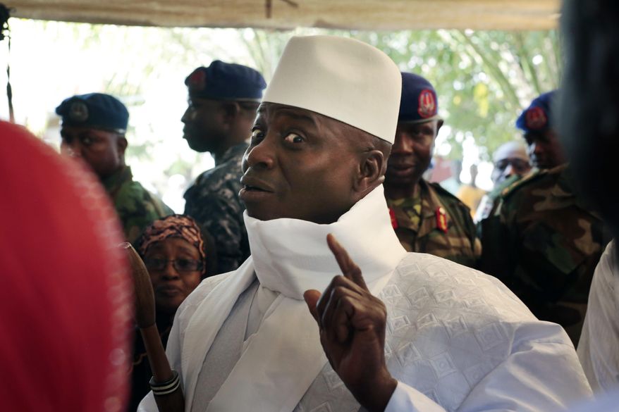 FILE - In this Thursday, Dec. 1, 2016 file photo, Gambia's President Yahya Jammeh shows his inked finger before voting in Banjul, Gambia. Gambia has launched a truth, reconciliation and reparations commission, launched Monday Oct. 15, 2018, to lay bare abuses committed under the 22-year rule of former leader Yahya Jammeh, with President Adama Barrow declaring the country's "dark days" are over. (AP Photo/Jerome Delay, File)