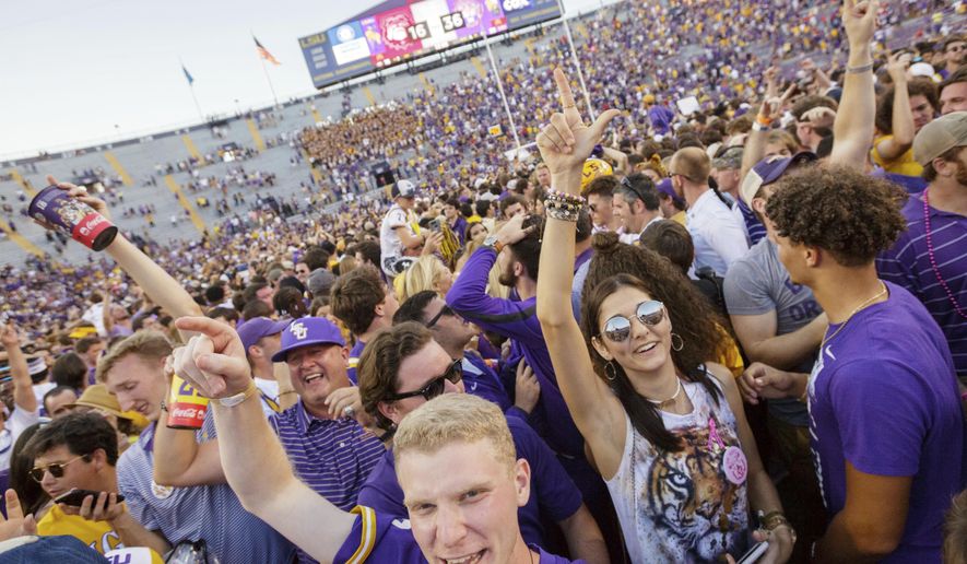 LSU fans rush the field after the Tigers 36-16 win over Georgia in an NCAA college football in Baton Rouge, La., Saturday, Oct. 13, 2018. (AP Photo/Matthew Hinton)