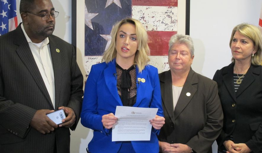 Meagan Simonaire, a Maryland state lawmaker, announces she is switching parties from Republican to Democrat on Monday, Oct. 15, 2018, in Annapolis, Md., partly because of President Donald Trump. Simonaire said she "can no longer remain a part of a party that condones his rhetoric" against women and minorities. Simonaire is standing with Del. Darryl Barnes, left, Del. Bonnie Cullison, and Kathleen Matthews, far left, who chairs the Maryland Democratic Party. (AP Photo/Brian Witte)
