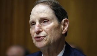 FILE - In this June 28, 2018, file photo, Sen. Ron Wyden, D-Ore., ranking member of the Senate Finance Committee, speaks during a hearing on the nomination of Charles Rettig for Internal Revenue Service Commissioner on Capitol Hill in Washington. Low-income people in states that haven’t expanded Medicaid are much more likely to forgo needed medical care than the poor in other states, according to a government report due out Monday, Oct. 15, amid election debates from Georgia to Utah over coverage for the needy. “States around the country have an opportunity to expand Medicaid to more people; these findings help show why it’s a winning proposition for states and the millions of Americans currently left out,” said Wyden, who requested the analysis. (AP Photo/Jacquelyn Martin, File)