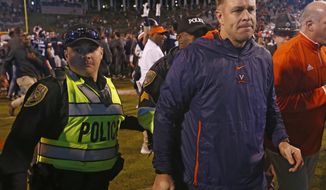 Virginia head coach Bronco Mendenhall heads to the locker room after an NCAA college football game in Charlottesville, Va., Saturday, Oct. 13, 2018. Virginia defeated Miami 16-13. (AP Photo/Steve Helber)