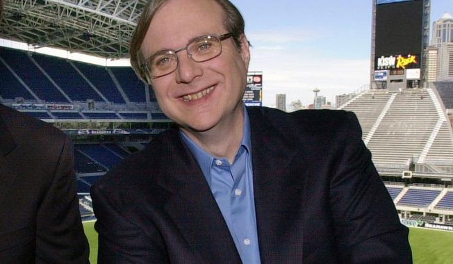 FILE - In this July 17, 2001 file photo, Seattle Seahawks owner Paul Allen appears in a suite in the team&#x27;s stadium in Seattle. Allen, billionaire owner of the Trail Blazers and the Seattle Seahawks and Microsoft co-founder, died Monday, Oct. 15, 2018 at age 65. Earlier this month Allen said the cancer he was treated for in 2009, non-Hodgkin’s lymphoma, had returned.  (AP Photo/Elaine Thompson, File)
