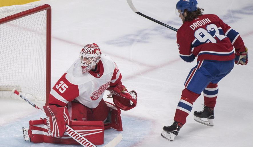Montreal Canadiens&#39; Jonathan Drouin scores on a penalty shot against Detroit Red Wings goaltender Jimmy Howard during first period NHL hockey action in Montreal, Monday, Oct. 15, 2018. (Graham Hughes/The Canadian Press via AP)