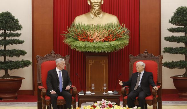 FILE - In this  Jan. 25, 2018, file photo, U.S. Secretary of Defense Jim Mattis, left, listens during talks with Vietnam&#x27;s Communist Party General Secretary Nguyen Phu Trong in Hanoi, Vietnam. Mattis is planning to make his second visit to Vietnam this year, signaling how vigorously the Trump administration is trying to counter China&#x27;s military assertiveness in the South China Sea by building up relations with smaller nations in the region. (AP Photo/Tran Van Minh, File)
