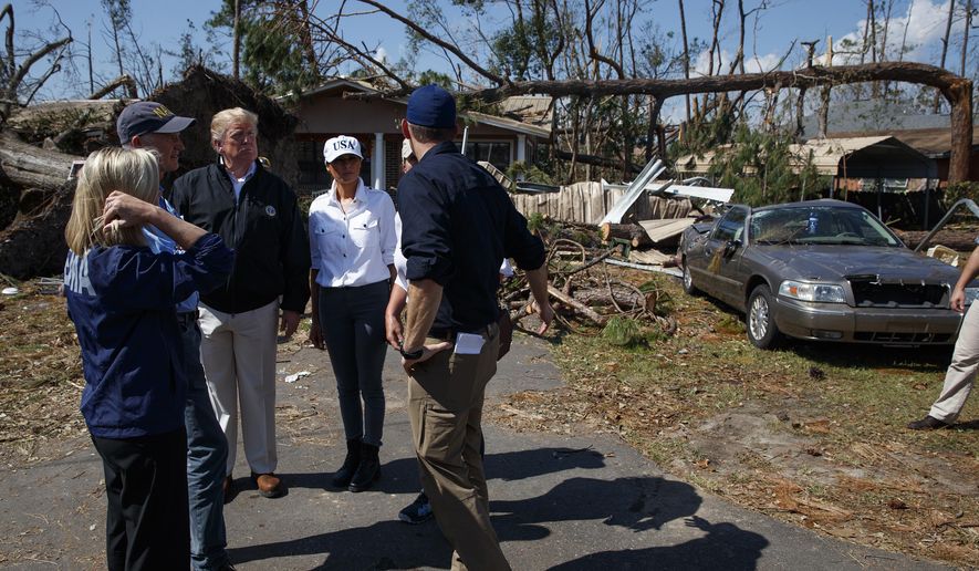 FEMA director Brock Long, right, talks with from left, Homeland Security Secretary Kirstjen Nielsen, Florida Gov. Rick Scott, President Donald Trump, first lady Melania Trump and Margo Anderson, Mayor of Lynn Haven, Fla., second from right, as they tour a neighborhood affected by Hurricane Michael, Monday, Oct. 15, 2018, in Lynn Haven, Fla. (AP Photo/Evan Vucci)