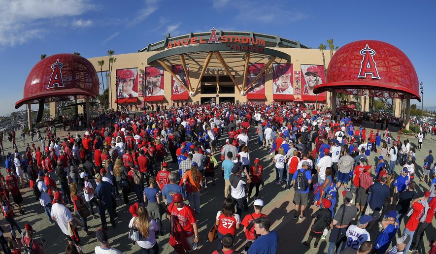 FILE - In this Monday, April 4, 2016 file photo, Fans line up outside Angel Stadium of Anaheim for an opening day baseball game between the Los Angeles Angels and the Chicago Cubs in Los Angeles. The Los Angeles Angels have opted out of their Angel Stadium lease with the city of Anaheim. The Angels informed the city of their decision Tuesday, Oct. 16, 2018.  (AP Photo/Mark J. Terrill, File)