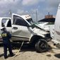 FILE - In this March 31, 2017 file photo provided by National Transportation Safety Board, Kristin Poland and David Pereira examine the pickup truck involved in a crash on March 29 on U.S. 83 near Garner State Park in Texas. Federal officials say a motorist’s use of marijuana and a sedative led to the collision with the church bus that killed 13 people. The National Transportation Safety Board said in a report released Tuesday, Oct. 16, 2018 that toxicology tests on Jack Dillon Young, who survived the March 2017 crash, found the drugs in his blood stream. According to the report, Young said he had taken twice the prescribed dosage of the sedative before the wreck. (Jennifer Morrison/NTSB via AP, file)