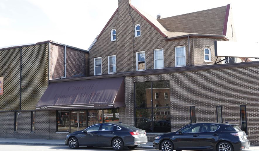 Exterior of the former Cantrell Funeral Home building is seen on Monday, Oct. 15, 2018 in Detroit. An anonymously written letter led Michigan inspectors to find badly decomposed remains of 11 infants hidden in a ceiling compartment of the shuttered Detroit funeral home. (AP Photo/Carlos Osorio)