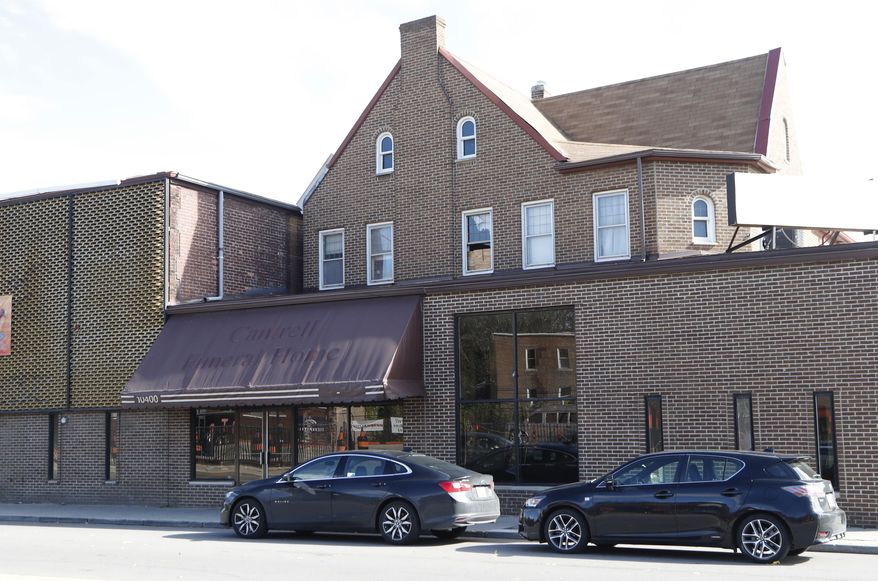 Exterior of the former Cantrell Funeral Home building is seen on Monday, Oct. 15, 2018 in Detroit. An anonymously written letter led Michigan inspectors to find badly decomposed remains of 11 infants hidden in a ceiling compartment of the shuttered Detroit funeral home. (AP Photo/Carlos Osorio)
