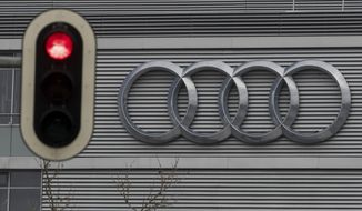 FILE -- In this Wednesday, March 15, 2017 photo a traffic sign shows a red light in front of the Audi headquarters in Ingolstadt, Germany.  Audi accepted a fine of 800 million euro (927 million US$) for it&#39;s involvement in the Diesel scandal. (Armin Weigel/dpa via AP, file)
