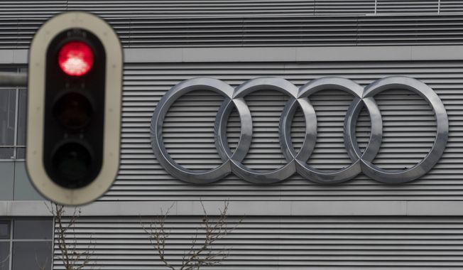 FILE -- In this Wednesday, March 15, 2017 photo a traffic sign shows a red light in front of the Audi headquarters in Ingolstadt, Germany.  Audi accepted a fine of 800 million euro (927 million US$) for it&#x27;s involvement in the Diesel scandal. (Armin Weigel/dpa via AP, file)