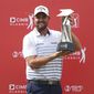 Marc Leishman of Australia poses with his trophy after winning the CIMB Classic golf tournament at Tournament Players Club (TPC) in Kuala Lumpur, Malaysia, Sunday, Oct. 14, 2018. (AP Photo/Vincent Phoon)