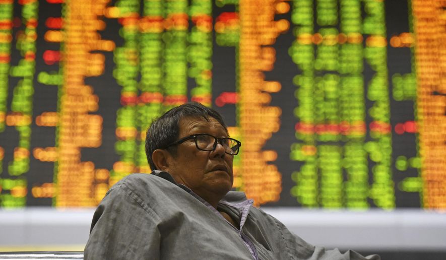 Investor sits at private stock trading boards at a private stock market gallery in Kuala Lumpur, Malaysia, Tuesday, Oct. 16, 2018. Asian markets were mostly higher on Tuesday, though Chinese benchmarks fell after the government reported inflation rose for the fourth straight month. (AP Photo/Yam G-Jun)
