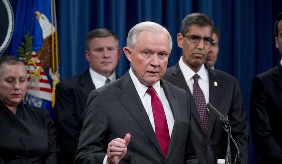 Attorney General Jeff Sessions accompanied by accompanied by Drug Enforcement Administration (DEA) Acting Administrator Uttam Dhillon, right, and other officials from the Drug Enforcement Administration, State Department, Treasury Department, Internal Revenue Service and Immigration and Customs Enforcement, speaks at a news conference to announce enforcement efforts against Cartel Jalisco Nueva Generacion, Tuesday, Oct. 16, 2018, at the Justice Department in Washington. (AP Photo/Andrew Harnik) ** FILE **