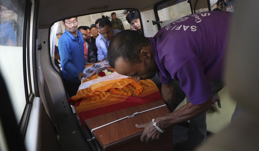 Friends are relatives carry coffins containing bodies of South Korean climbers killed over the weekend in a fierce storm on Nepal’s Gurja Himal mountain after theywere brought to the Tribhuvan University Teaching Hospital in Kathmandu, Nepal, Tuesday, Oct. 16, 2018. The bodies were driven to the airport and were set to be flown to Seoul, South Korea&#39;s capital, later Tuesday. The bodies of five South Korean climbers are heading home amid calls to improve weather warning systems on Nepal&#39;s mountains. (AP Photo/Bikram Rai)