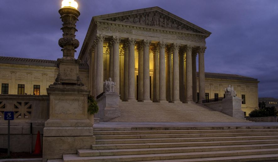 In this Oct. 5, 2018 photo the U. S. Supreme Court building stands quietly before dawn in Washington.  A couple of liberal Harvard law professors are lending their name to a new campaign that wants to build support for expanding the Supreme Court by four justices. The campaign being launched Wednesday also wants to increase the size of the lower federal courts to counteract what it terms “Republican obstruction, theft and procedural abuse” of the federal judiciary.   (AP Photo/J. David Ake)