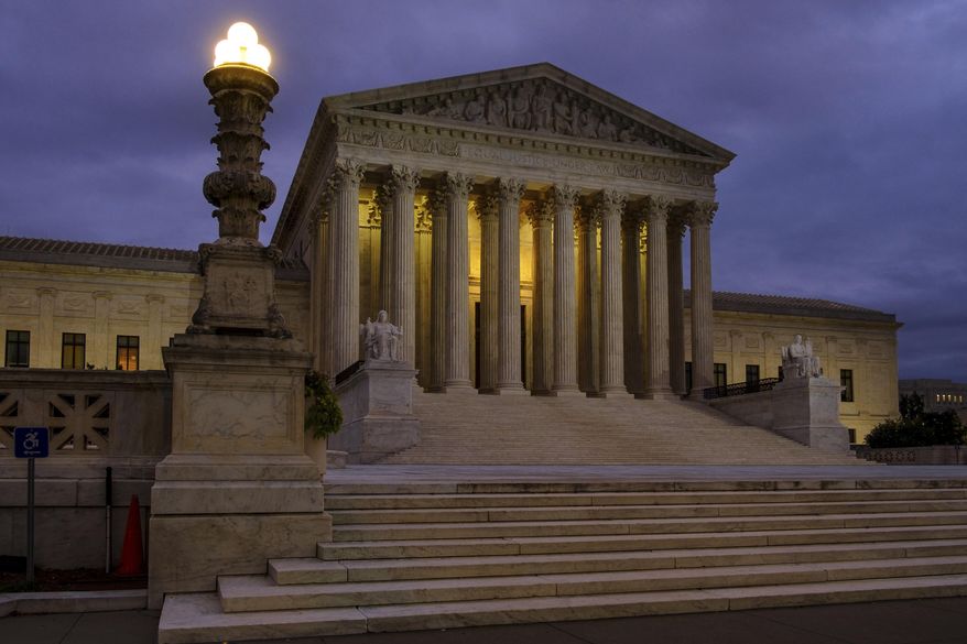 In this Oct. 5, 2018 photo the U. S. Supreme Court building stands quietly before dawn in Washington.  A couple of liberal Harvard law professors are lending their name to a new campaign that wants to build support for expanding the Supreme Court by four justices. The campaign being launched Wednesday also wants to increase the size of the lower federal courts to counteract what it terms “Republican obstruction, theft and procedural abuse” of the federal judiciary.   (AP Photo/J. David Ake)