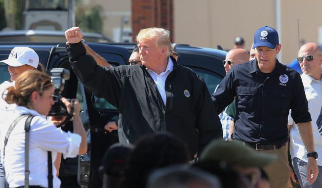 President Donald Trump raises his fist to chants of &amp;quot;USA&amp;quot; during a visit Monday, Oct. 15, 2018, to Lynn Haven, Fla., to see storm damage and recovery efforts following Hurricane Michael. Trump marveled at the roofless homes and uprooted trees he saw Monday while touring Florida Panhandle communities ravaged by the force of the hurricane. (Michael Snyder/Northwest Florida Daily News via AP)