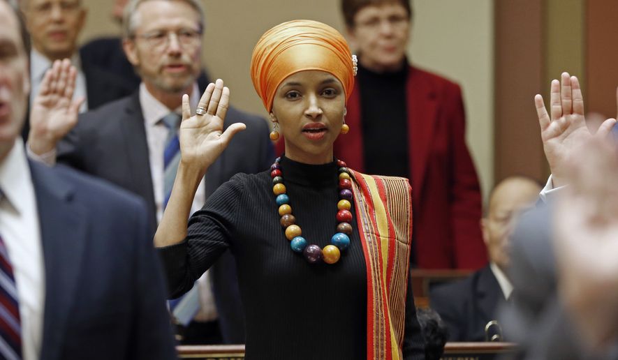 State Rep. Ilhan Omar takes the oath of office as the 2017 Legislature convened Tuesday, Jan. 3, 2017, in St. Paul, Minn. Omar is the nation&#39;s first Somali-American to be elected to a state legislature. (AP Photo/Jim Mone)