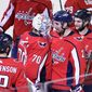 Washington Capitals defenseman Matt Niskanen (2) celebrates with Washington Capitals goaltender Braden Holtby (70) and others after an NHL hockey game, Wednesday, Oct. 17, 2018, in Washington. Niskanen scored the game-winning goal in overtime. The Capitals won 4-3 in overtime. (AP Photo/Nick Wass)