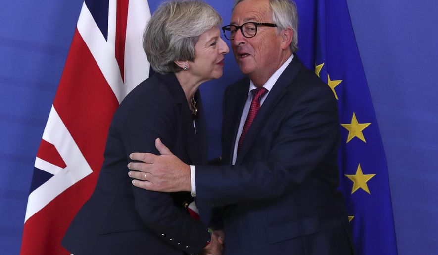 British Prime Minister Theresa May, left, hugs Jean-Claude Juncker, President of the European Commission, as they meet in Brussels, Wednesday, Oct. 17, 2018 when European leaders meet to negotiate on terms of Britain&#x27;s divorce from the European Union. (AP Photo/Francisco Seco)