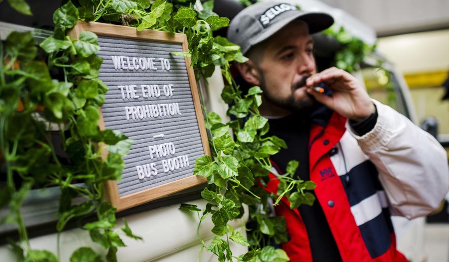 Matthew Macdougall smokes a joint during a &amp;quot;Wake and Bake&amp;quot; legalized marijuana event in Toronto on Wednesday, Oct. 17, 2018. Canada became the largest country with a legal national marijuana marketplace as sales began early Wednesday in Newfoundland. (Christopher Katsarov/The Canadian Press via AP)