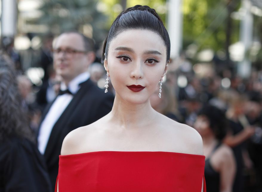 FILE - In this May 24, 2017, file photo, Chinese actress Fan Bingbing poses for photographers as she arrives for the screening of the film The Beguiled at the 70th international film festival, Cannes, southern France. The director of the film “Air Strike,” featuring Fan Bingbing, says its release has been canceled in the wake of her disappearance and conviction on tax evasion charges. (AP Photo/Thibault Camus, File)