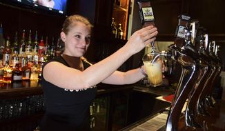 Hillary James draws an Old King Kolsch beer at the Bricktown Brewery, October 5, 2018, in Oklahoma City. Under the old alcohol laws, restaurants that served craft beer, better known as brewpubs, were not allowed to brew beer above 3.2 percent alcohol by volume. When the laws changed this month, that regulation was gone. (Mark Hancock/The Journal Record via AP)
