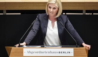 FILE - The May 31, 2018 file photo shows  Jessica Biessmann of the Alternative for Germany, AfD, speaking in the Berlin state parliament. The far-right Alternative for Germany party wants to expel the regional lawmaker who posed in front of wine bottles featuring pictures of Nazi leader Adolf Hitler. German news agency dpa reported Wednesday that the party’s Berlin chapter has started proceedings to force out Biessman. (Gregor Fischer/dpa via AP)