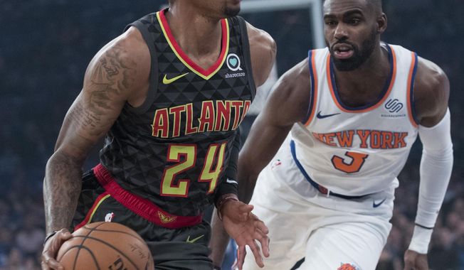 Atlanta Hawks guard Kent Bazemore (24) drives to the basket against New York Knicks guard Tim Hardaway Jr. (3) during the first half of an NBA basketball game, Wednesday, Oct. 17, 2018, at Madison Square Garden in New York. (AP Photo/Mary Altaffer)