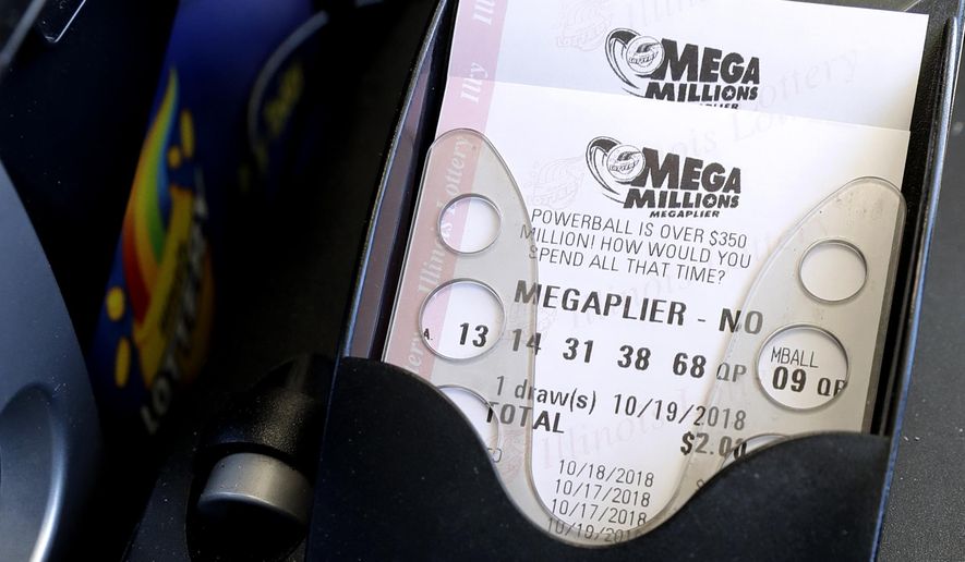 Mega Millions lottery tickets are printed out of a lottery machine at a convenience store Wednesday, Oct. 17, 2018, in Chicago. The estimated jackpot for Friday's drawing would be the second-largest lottery prize in U.S. history with a jackpot estimated to exceed $900 million. (AP Photo/Nam Y. Huh)