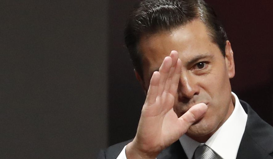 FILE - In this Sept. 3, 2018 file photo, Mexican President Enrique Pena Nieto waves to guests as he arrives to deliver his sixth and final State of the Nation address at the National Palace in Mexico City.  The Pena Nieto adminsitration is looking to protect itself from future investigation of corruption once it leaves power. (AP Photo/Rebecca Blackwell, File)