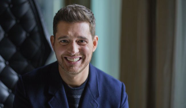 FILE - In this Tuesday, Oct. 18, 2016 file photo,Canadian singer Michael Buble poses for a photo to promote the upcoming Oct. 21 release of his new album "Nobody But Me" in Toronto. Grammy-winning singer Michael Buble is shutting down rumors that he’s going to retire, saying he was misquoted in a recent interview. Buble told The Associated Press on Tuesday, Oct. 16, 2018 that he is not planning on retiring anytime soon. The Canadian singer is disputing an Oct. 13 interview published in the Daily Mail that said he would be would be quitting music after the release of his upcoming album “Love,” which will be released Nov. 16. (Michelle Siu/The Canadian Press via AP, File)