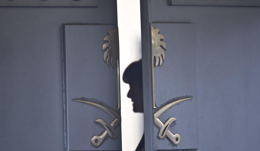 A Consulate staff is seen behind the entrance of the Saudi Arabia&#39;s Consulate in Istanbul, Wednesday, Oct. 17, 2018. On Wednesday a pro-government Turkish newspaper published a report made from what they described as an audio recording of Saudi writer and journalist Jamal Khashoggi&#39;s alleged torture and slaying at the Saudi Consulate in Istanbul. (AP Photo/Petros Giannakouris)