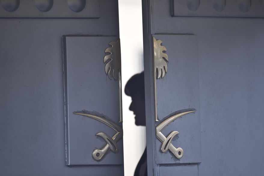 A Consulate staff is seen behind the entrance of the Saudi Arabia&#39;s Consulate in Istanbul, Wednesday, Oct. 17, 2018. On Wednesday a pro-government Turkish newspaper published a report made from what they described as an audio recording of Saudi writer and journalist Jamal Khashoggi&#39;s alleged torture and slaying at the Saudi Consulate in Istanbul. (AP Photo/Petros Giannakouris)