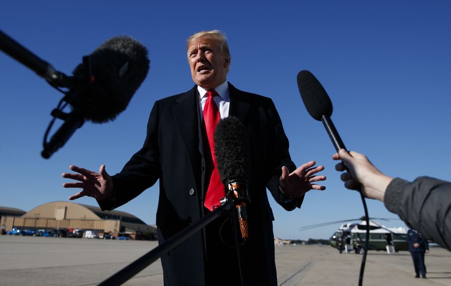 President Donald Trump talks to the media before boarding Air Force One, Thursday, Oct. 18, 2018, in Andrews Air Force Base, Md., en route to campaign stops in Montana, Arizona and Nevada.