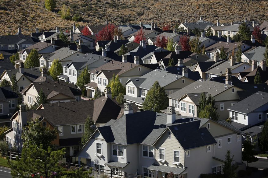 MOVING IN ADVANCE FOR USE ON SATURDAY OR THEREAFTER - In this Oct. 12, 2018, photo, homes fill a small valley in Reno, Nev. A population inrush to Nevada has been driven by people seeking more affordable housing and a growing tech industry around Reno. (AP Photo/John Locher)