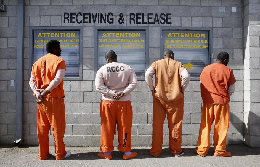 In this Feb. 20, 2014, file photo, prisoners from Sacramento County await processing after arriving at the Deuel Vocational Institution in Tracy, Calif. California will reconsider life sentences for thousands of nonviolent third-strike criminals by allowing them to seek parole under a ballot measure approved by voters two years ago. Court documents obtained by the Associated Press on Thursday, Oct. 18, 2018, show Gov. Jerry Brown's administration will include the repeat offenders in Proposition 57's early release program. (AP Photo/Rich Pedroncelli, file)