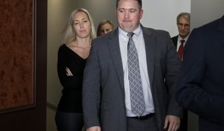 CORRECTS FIRST NAME OF WIFE FROM TANELLA TO JANELLA- Boston police officer Kurt Stokinger, front, and his wife Janella Stokinger, left, enter a conference room before a news conference at a law office, Thursday, Oct. 18, 2018, in Boston. The officer is suing an online marketplace where the gun used to shoot him was sold. The lawsuit filed Thursday by the Brady Center to Prevent Gun Violence on behalf of officer Kurt Stokinger alleges that Armslist enables illegal gun sales and lacks safeguards to prevent guns from getting into the wrong hands. (AP Photo/Steven Senne)