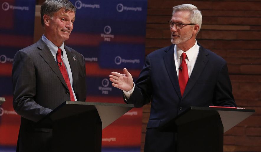 Republican candidate Mark Gordon, left, reacts as Constitution Party candidate, Rex Rammell, speaks during the Wyoming gubernatorial debate at Casper College Thursday, Oct. 18, 2018, in Casper, Wyo. (Josh Galemore/The Casper Star-Tribune via AP)