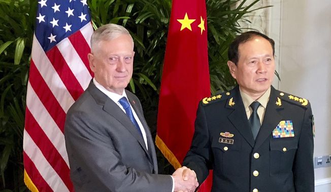 U.S. Defense Secretary Jim Mattis, left, meets Chinese Defense Minister Wei Fenghe in Singapore Thursday, Oct. 18, 2018. After a rocky few months, Pentagon officials say they sense that relations with the Chinese military may be stabilizing. (AP Photo/Robert Burns) ** FILE **