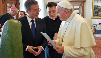 South Korean President Moon Jae-in, left, talks with Pope Francis during a private audience at the Vatican, Thursday, Oct. 18, 2018. South Korea&#39;s president is in Italy for a series of meetings that culminated with an audience with Pope Francis at which he&#39;s expected to extend an invitation from North Korean leader Kim Jong Un to visit. (Alessandro Di Meo/ANSA via AP)