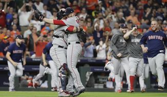 Boston Red Sox relief pitcher Craig Kimbrel celebrates with catcher Christian Vazquez winning the baseball American League Championship Series against the Houston Astros on Thursday, Oct. 18, 2018, in Houston. (AP Photo/David J. Phillip)
